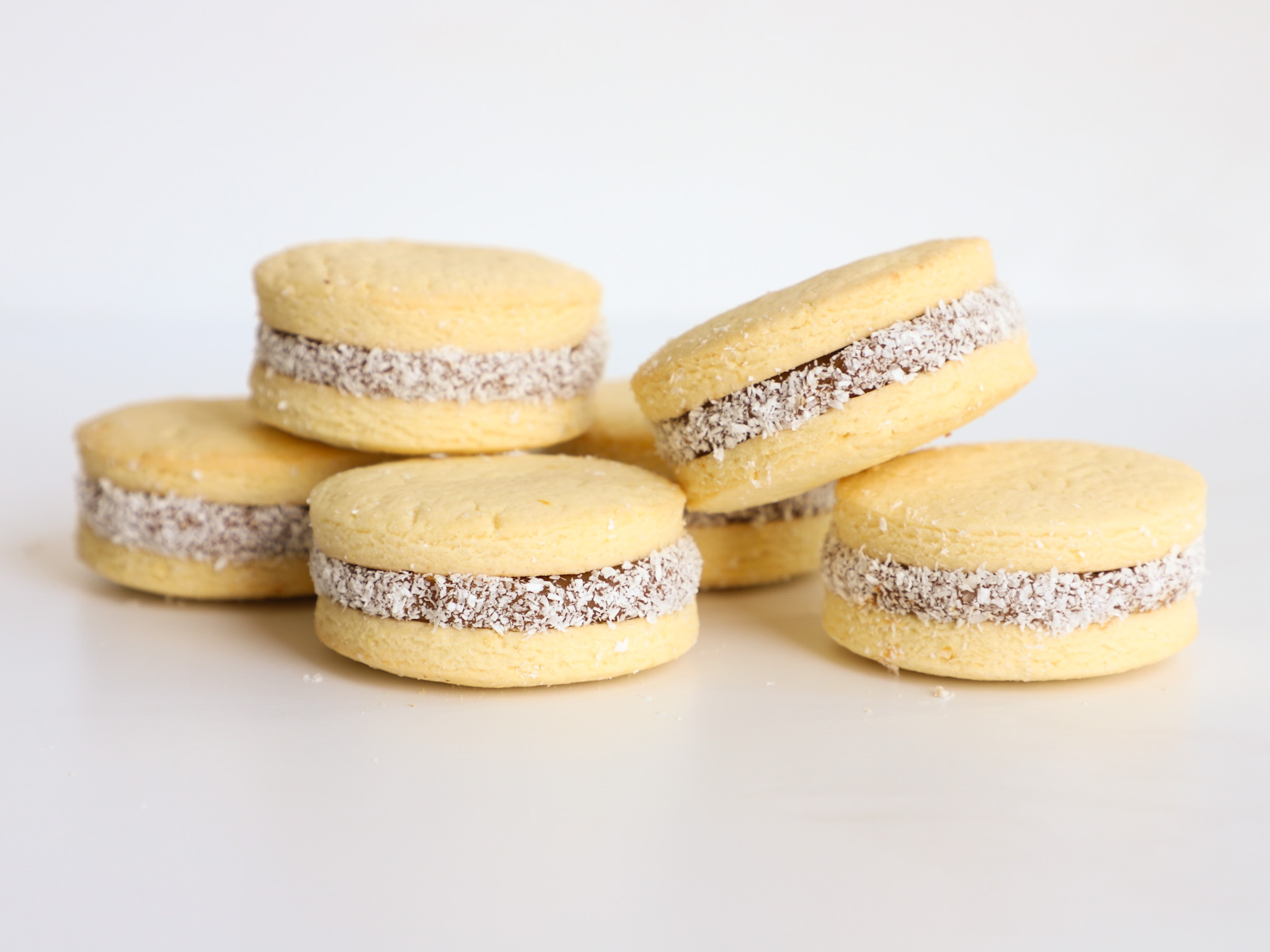 ALFAJORES DE MAICENA <br><span style="font-family: 'Spartan', sans-serif;font-size:13px;"><p>Alfajores clásicos de maicena y dulce de leche, con coco rallado en su contorno. </p><b>$1.700 (Por unidad -Ø4 cm.)</b></span>